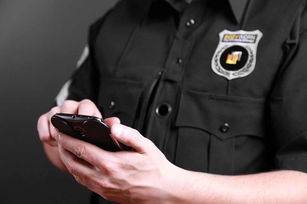 Law enforcement officer using a body camera.