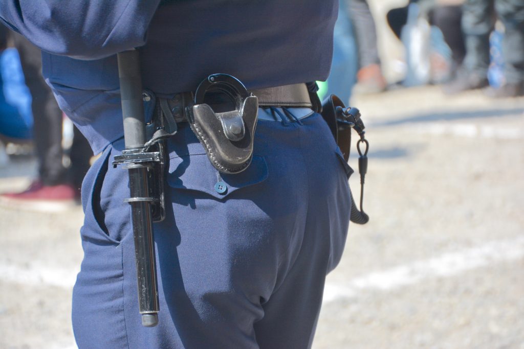 police mans lower backside and belt. 
