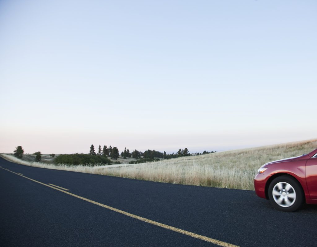 Car driving on rural highway.
(safe driving laws)