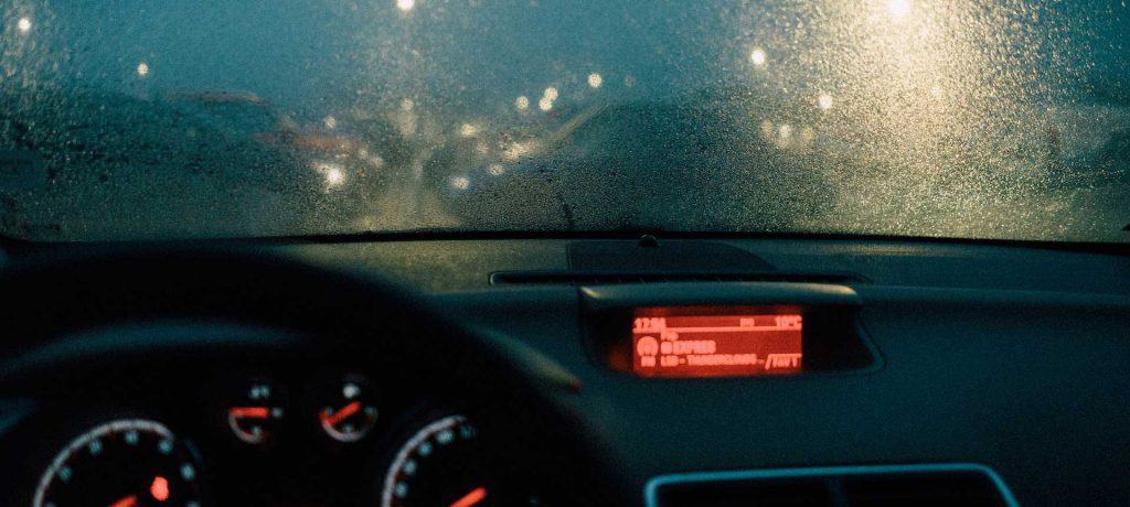 Car dash during a dark, rainy drive